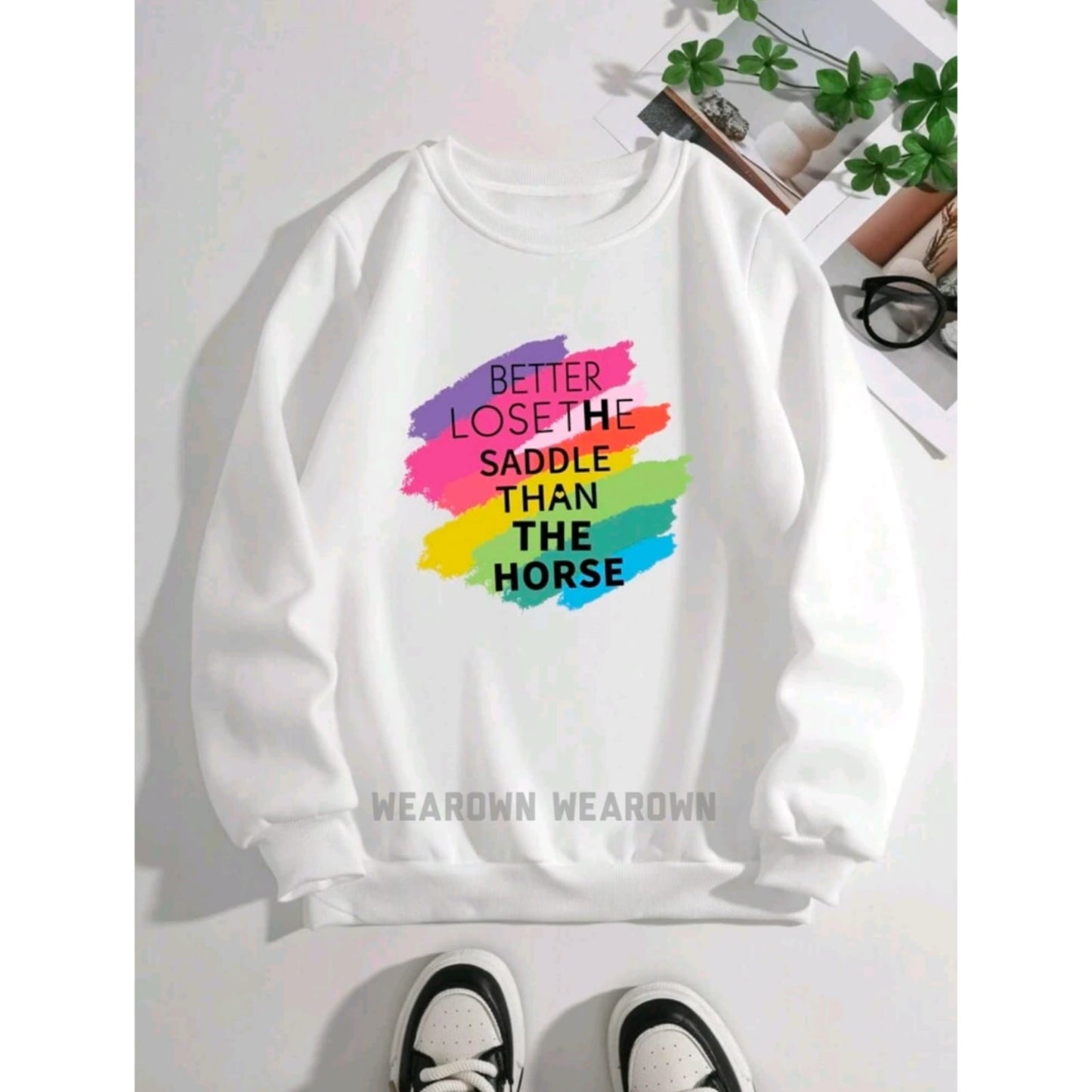 White sweatshirt with better lose the saddle than the horse